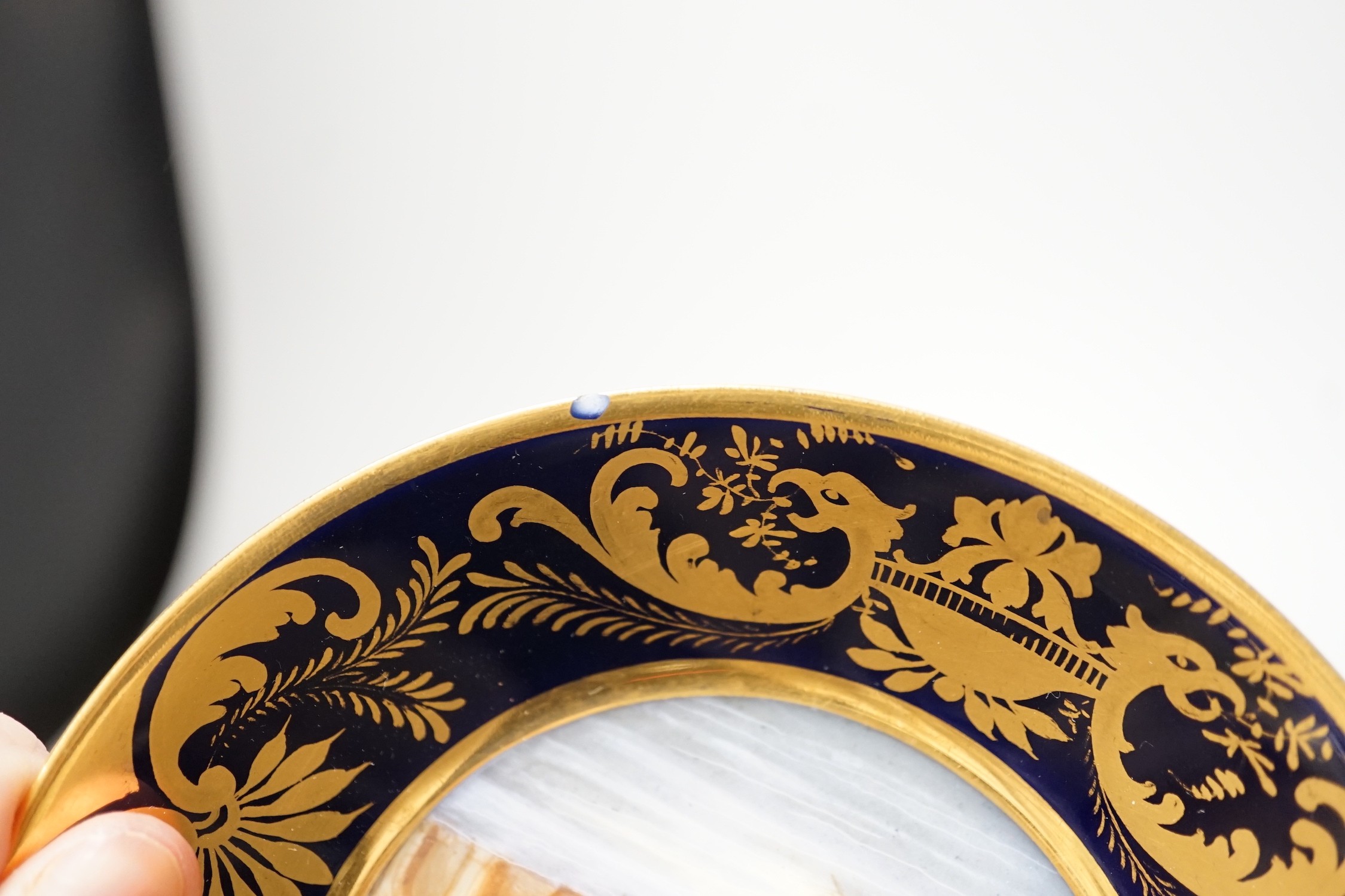 A Continental Derby style cup and saucer, 8cm tall overall